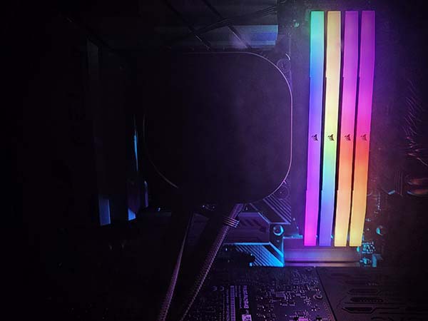 Close up of a computer motherboard with 4 Corsair RGB sticks of memory
